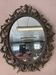 Miroir en bronze à volutes style rocaille