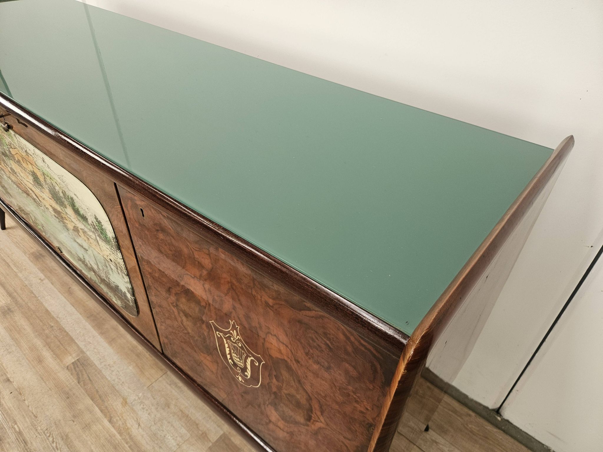 1950s mahogany sideboard with a glass top and central bar.