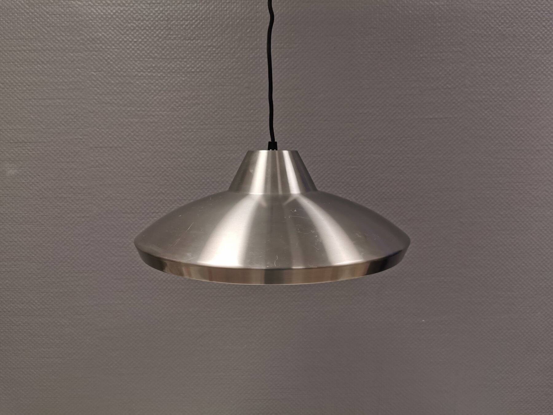 Slim silver-colored hanging lamp with a large diameter. Denmark 1980s