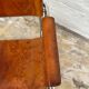 Vintage aluminum tube and tan leather armchair