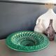Large pierced earthenware fruit bowl glazed in green and gold.