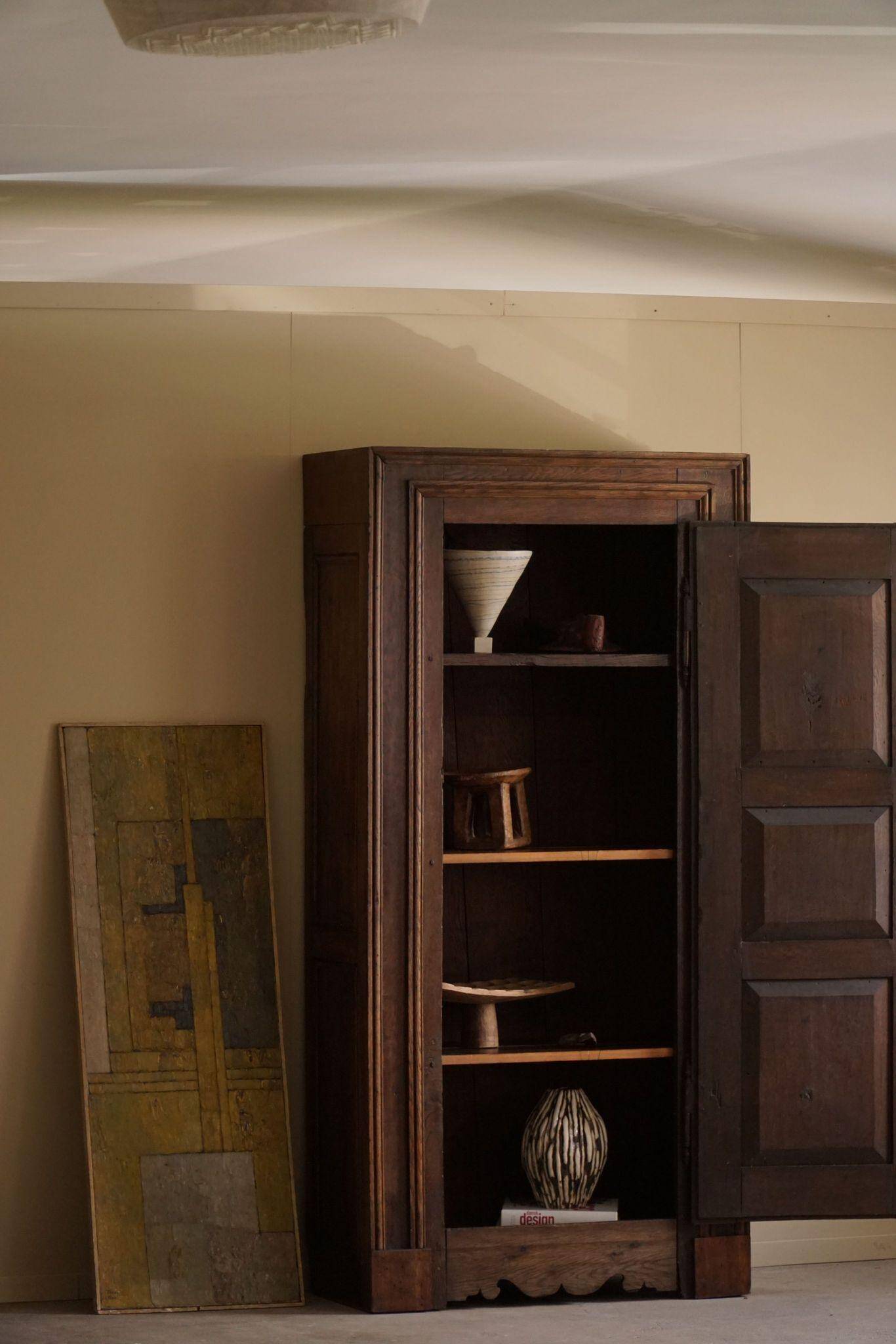Tall antique oak wardrobe, made by a French cabinetmaker, late 19th century.