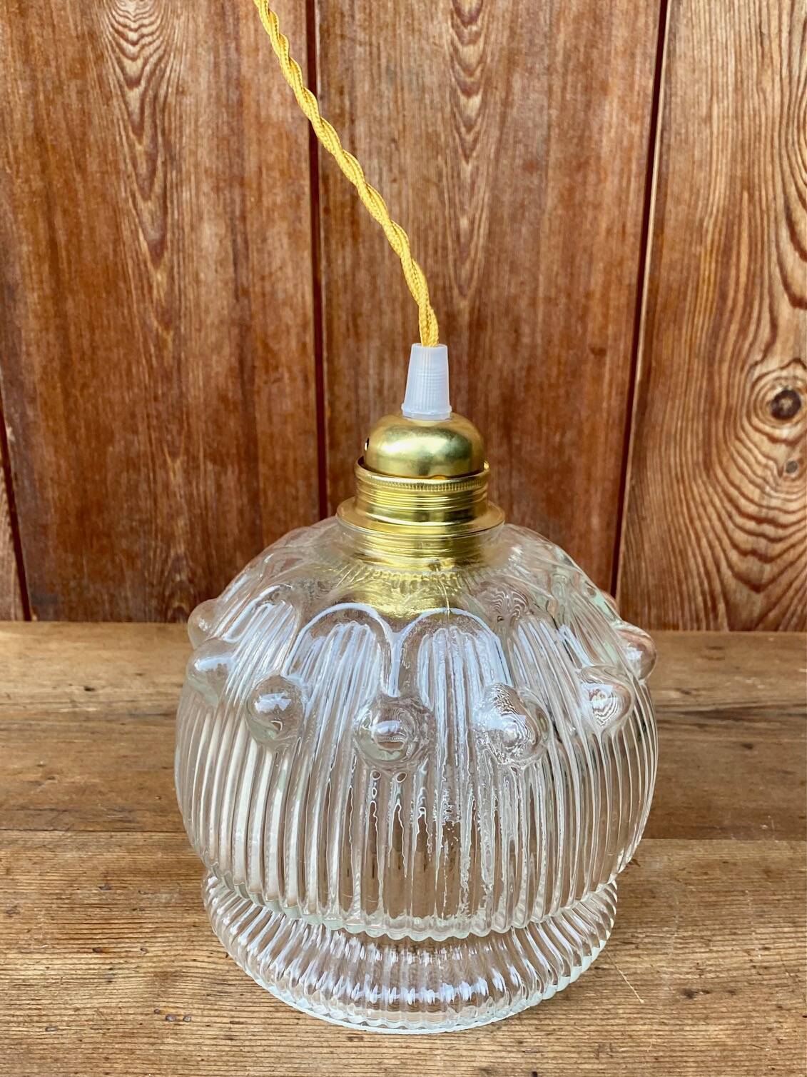 Vintage flower-shaped transparent glass pendant globe.