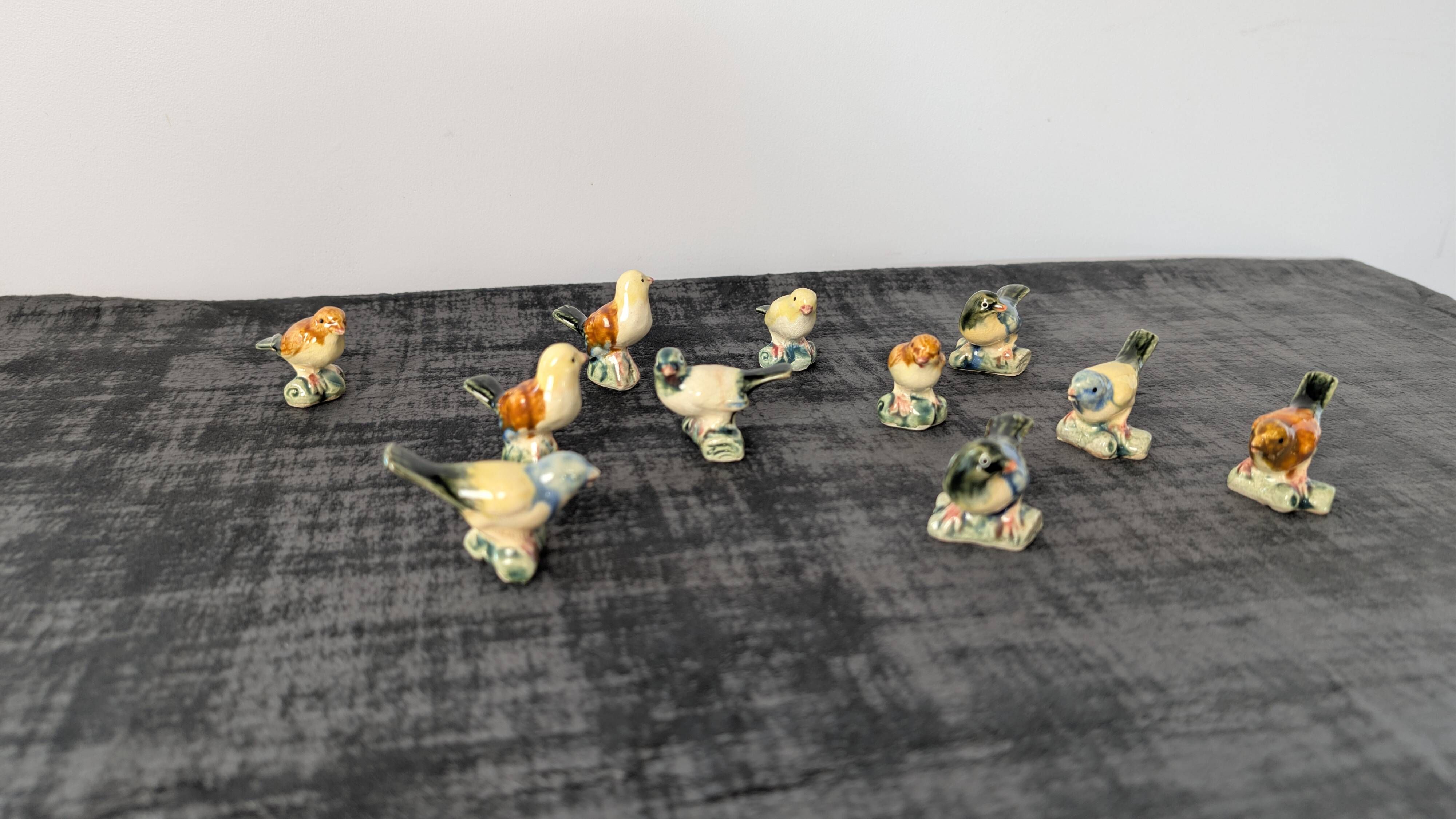 Set of 11 miniature birds in polychrome glazed ceramic.
