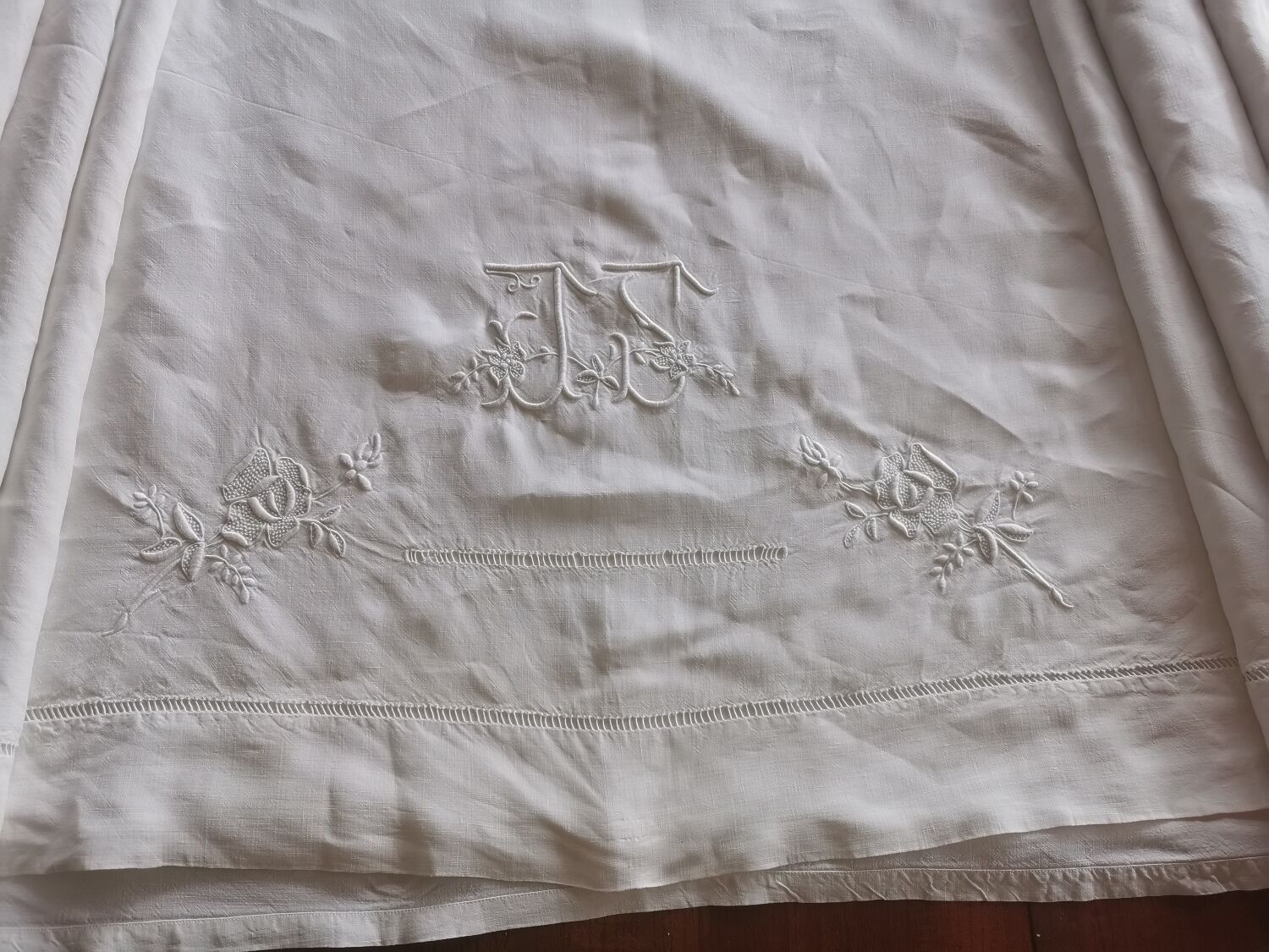 Antique embroidered linen sheet with a monogram.