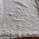Antique embroidered linen sheet with a monogram.