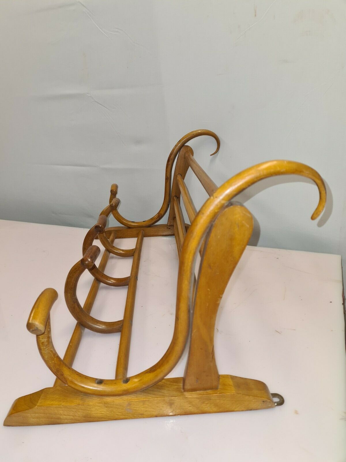 Coat rack with curved wooden hat holder