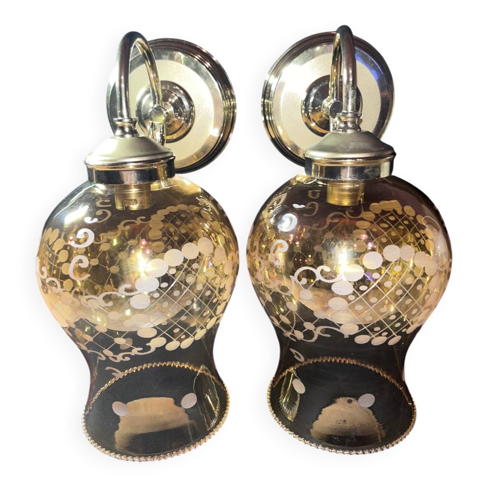 Pair of vintage wall sconces in brass with amber glass globes.