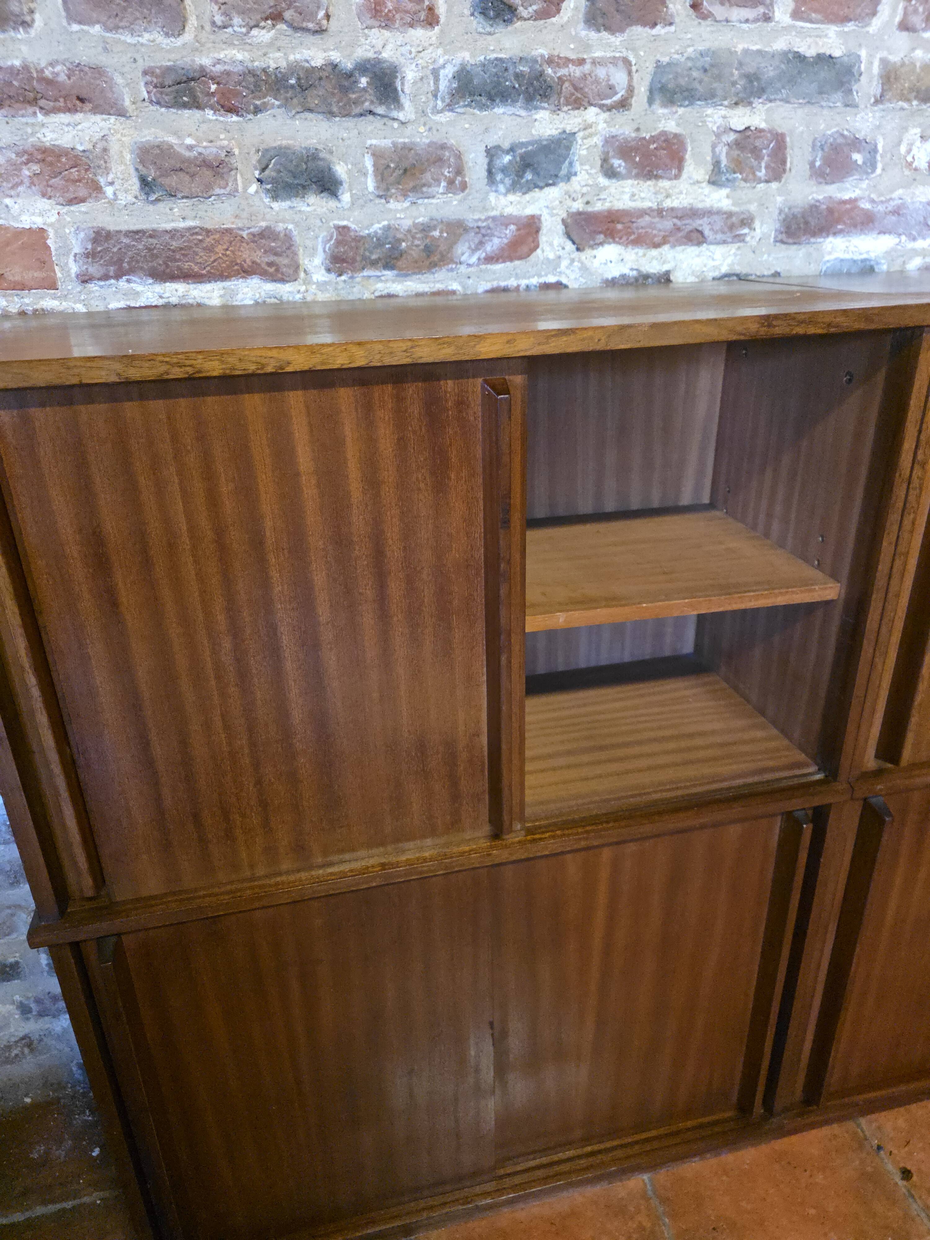 Modular corner library Oscar from the 1960s with sliding doors.