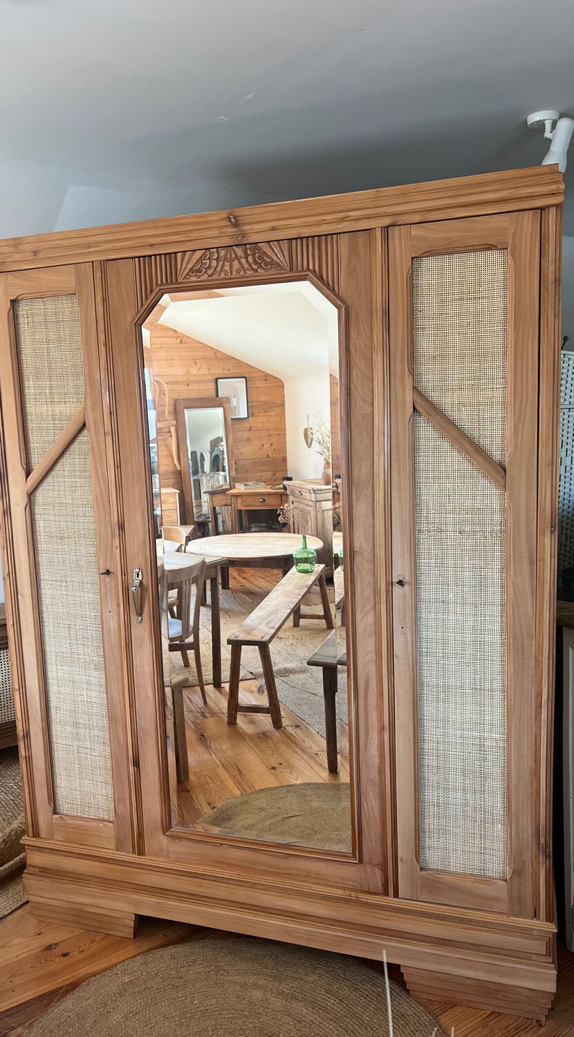 Large antique wardrobe made of solid raw wood and natural caning.
