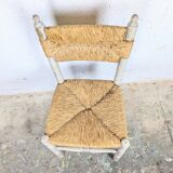 Rustic chair made of turned wood and straw.