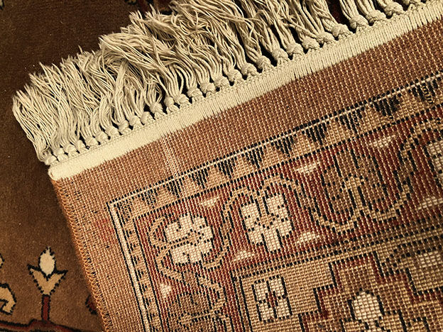 Wool carpet with oriental decoration on a brown background