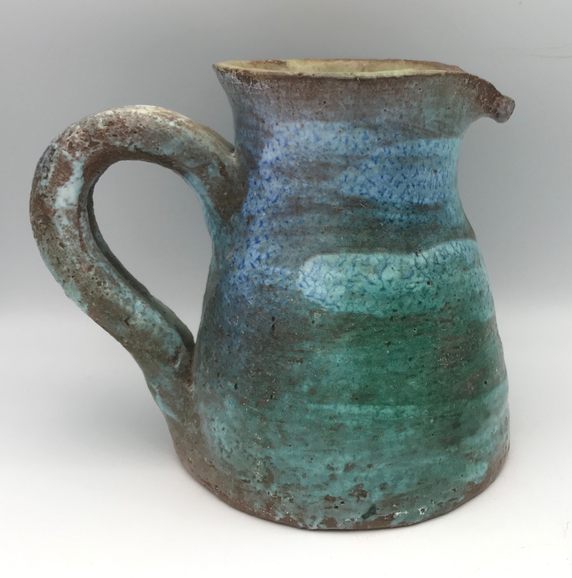 Vintage broc pitcher in enamelled sandstone with effect of blue shades, turquoise green signed