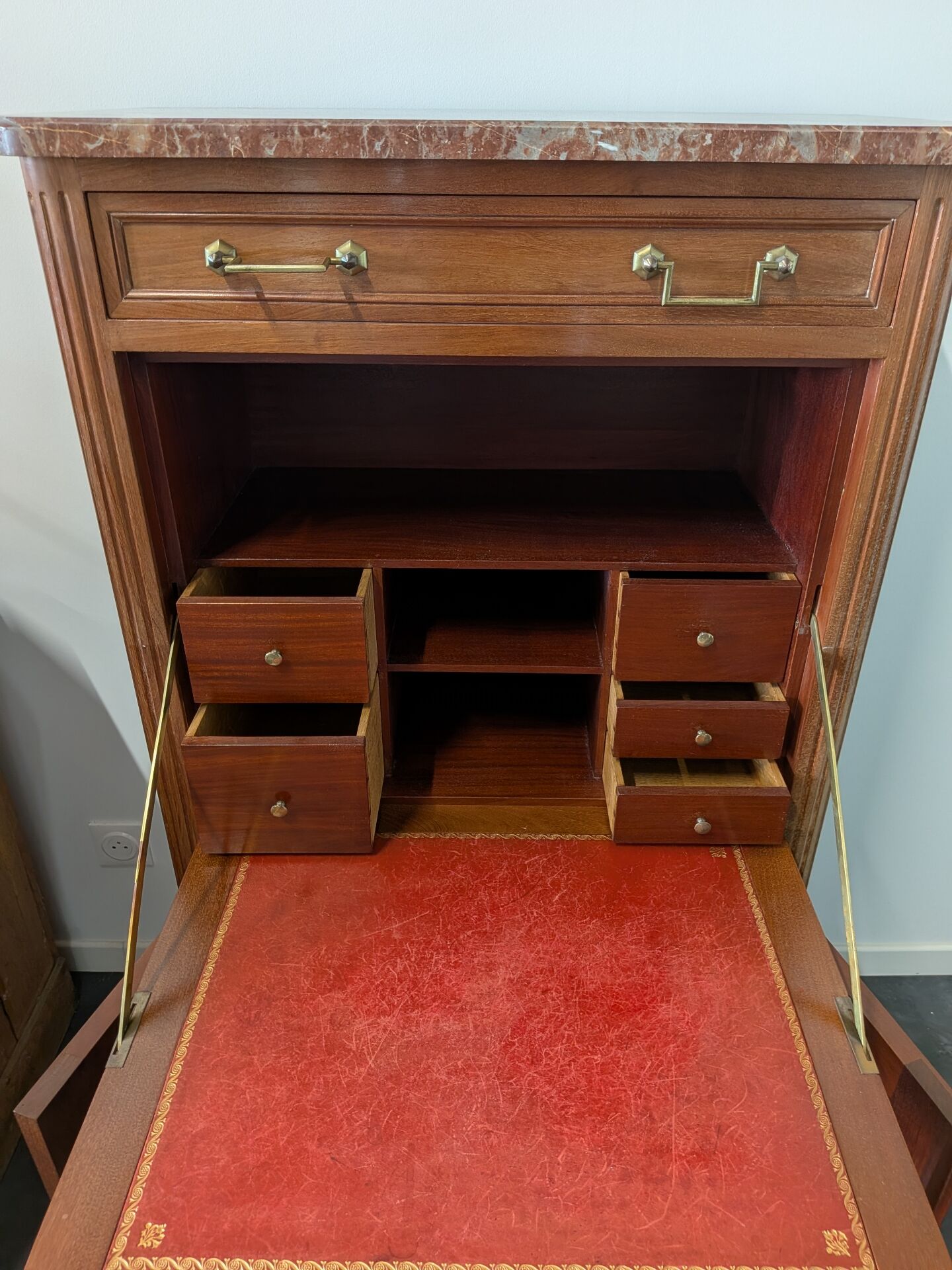 Secretary with a drop-leaf in Louis XVI style made of mahogany and royal red marble.