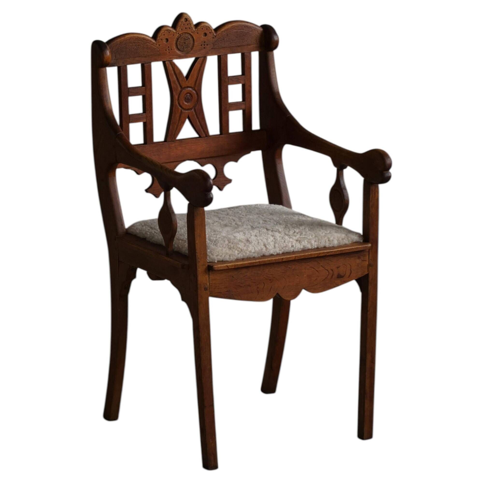 Danish popular art armchair in oak with a lambswool seat, early 20th century, 1930s.