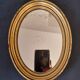 Old golden oval mirror