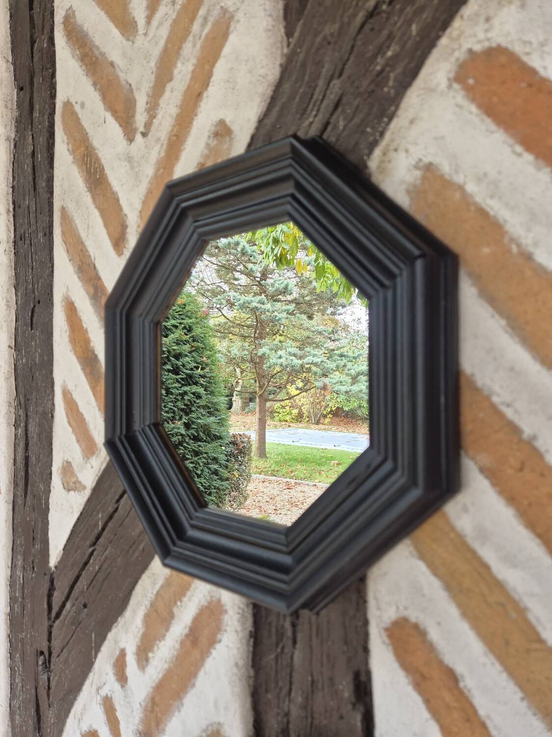 Octagonal black wood mirror
