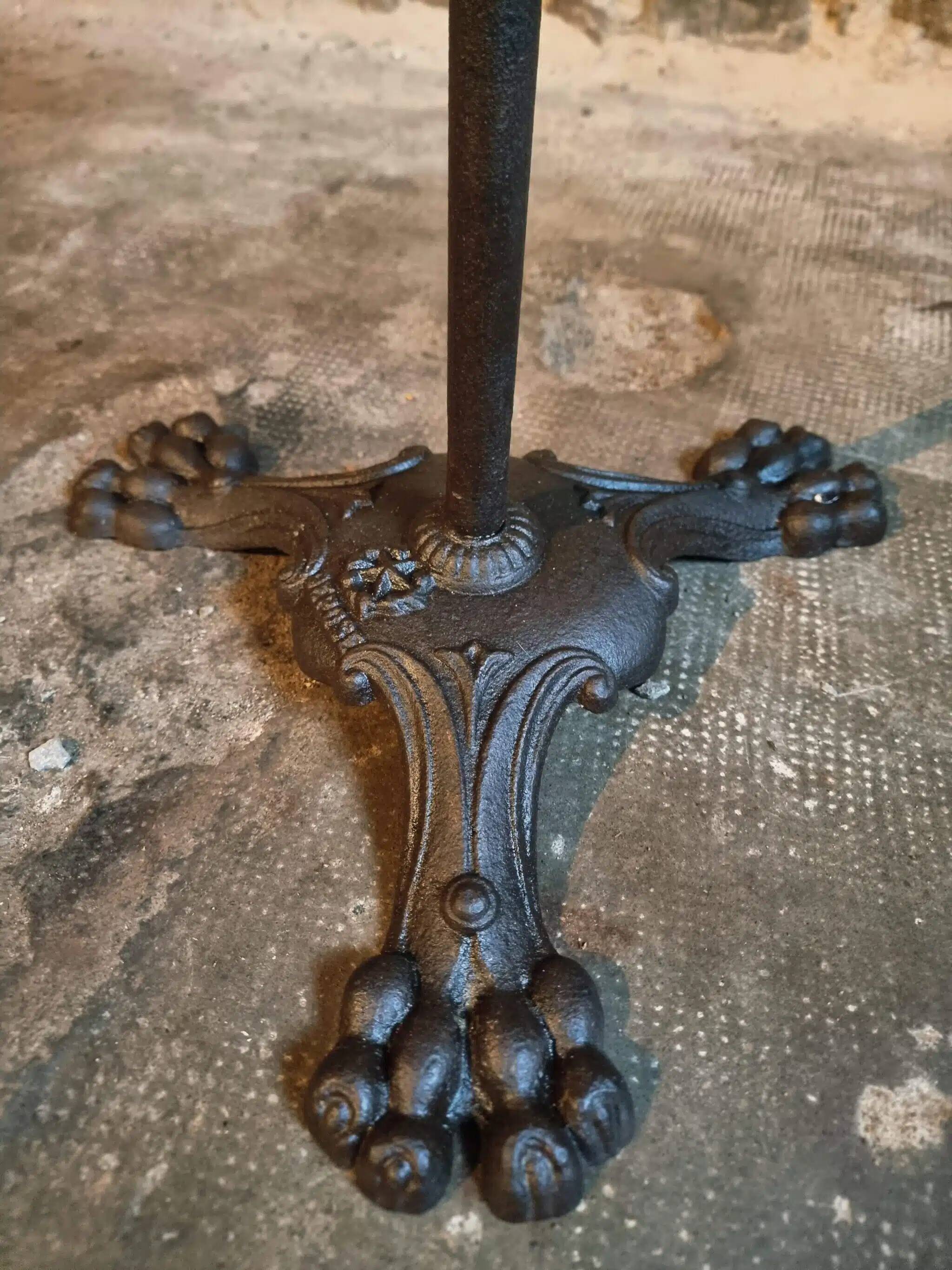 Old French bistro table with a marble top and a cast iron base.