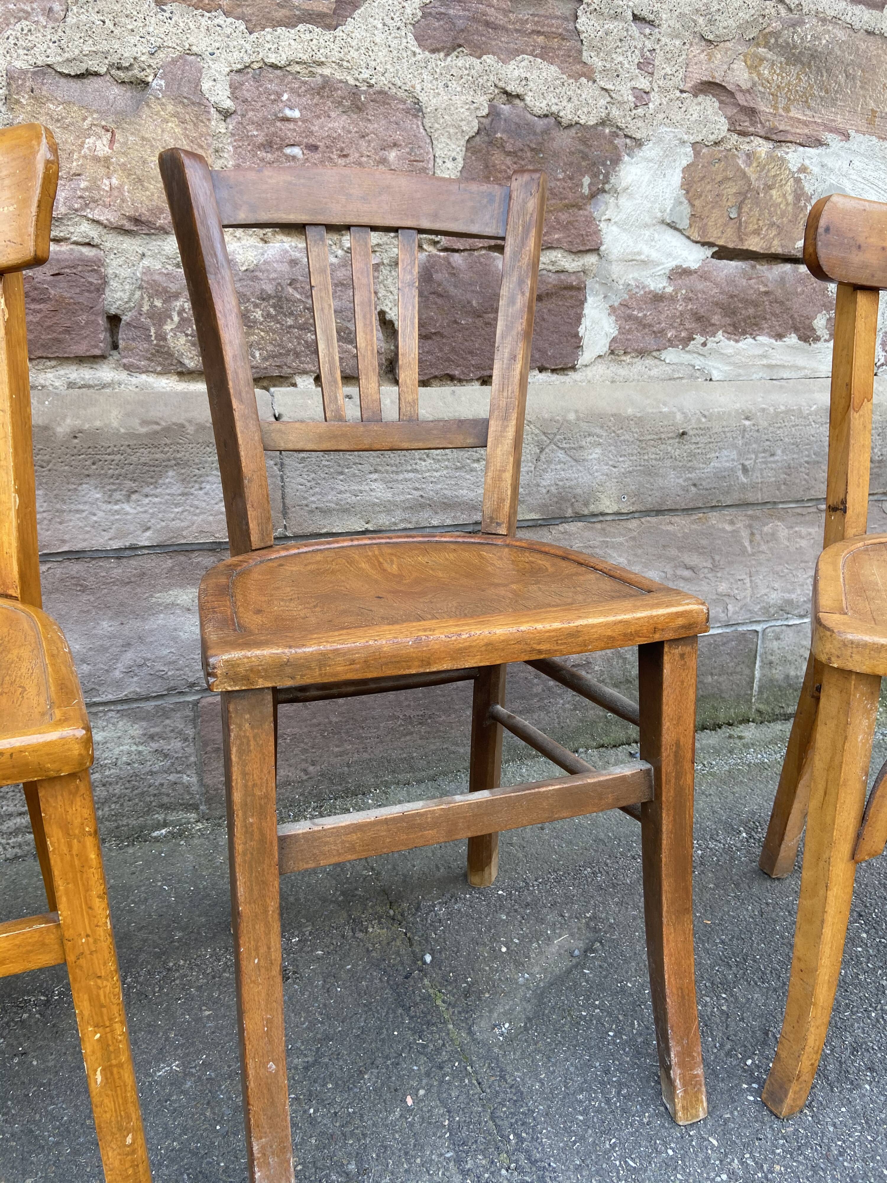 4 mismatched curved wooden bistro chairs