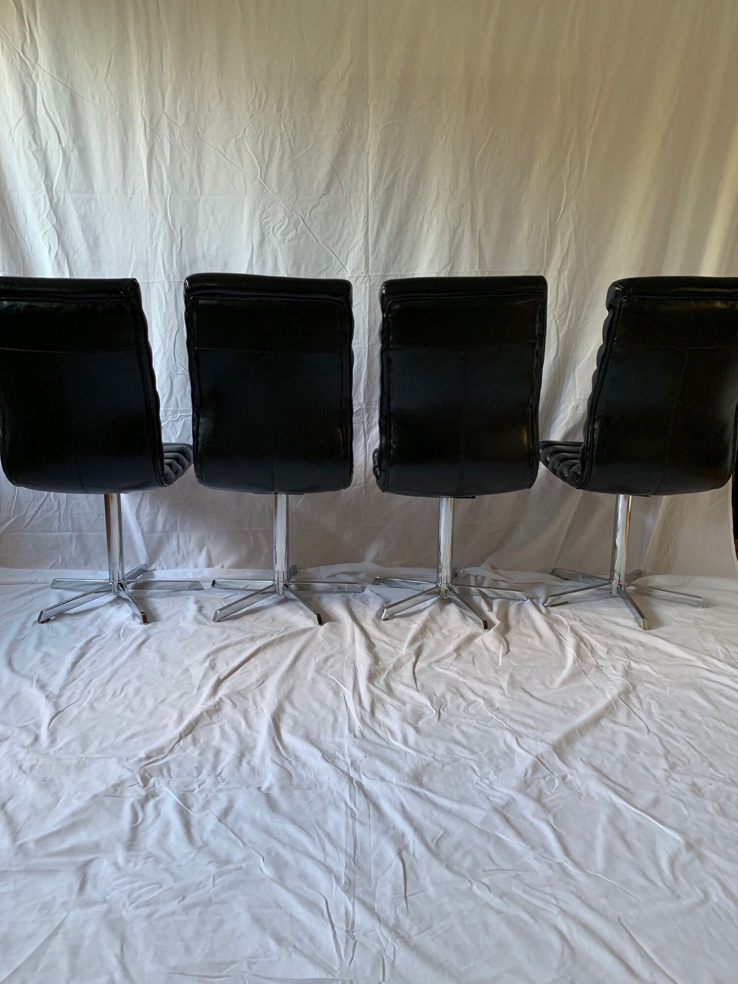 A set of four leather chairs, Italy, 80s
