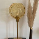 Table lamp with an antique vintage gold globe, mounted on a gold base