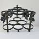Vintage black wrought iron bottle holder decorated with vine leaves