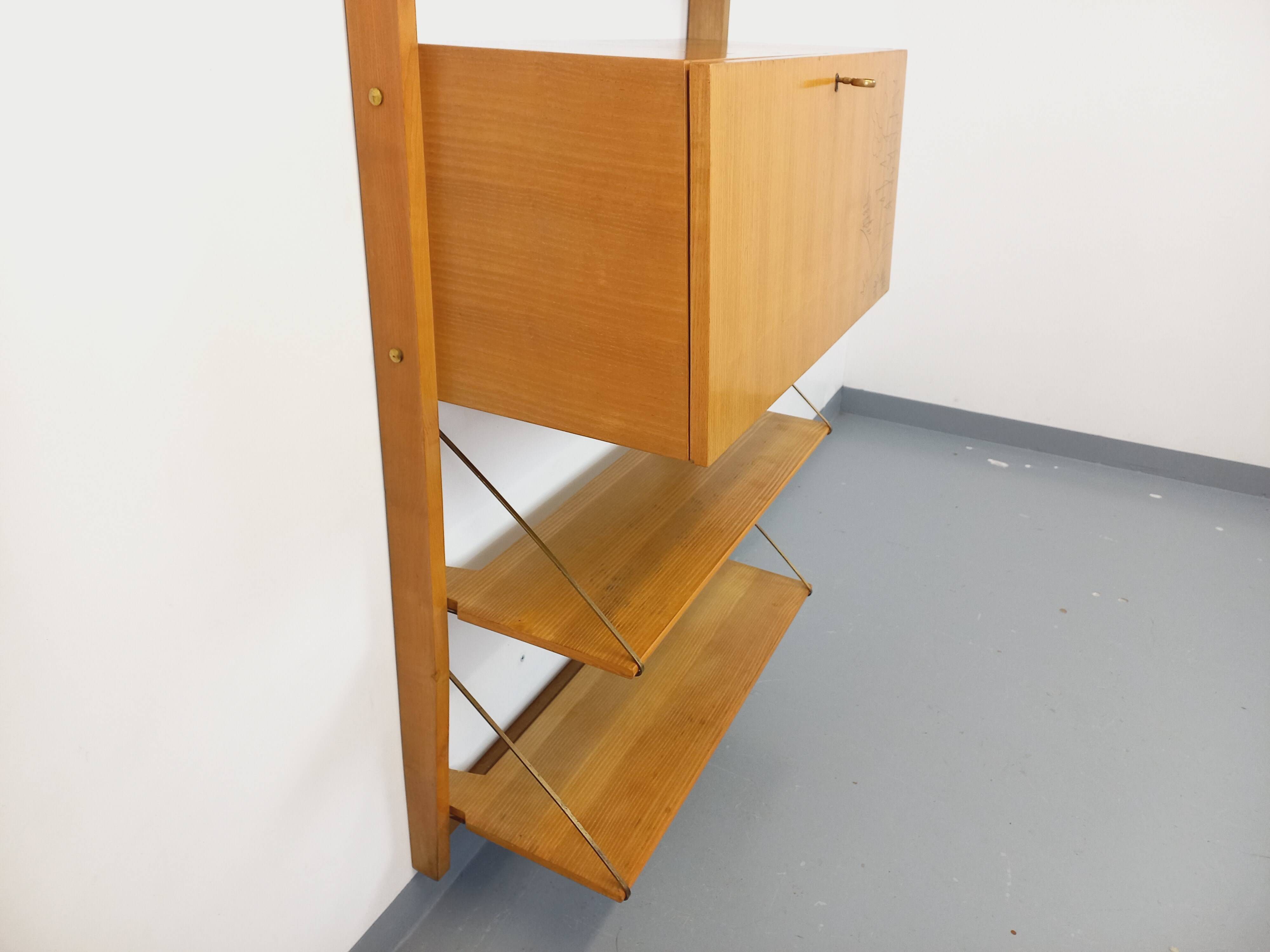 Wall shelf library with vintage light wood secretary bar