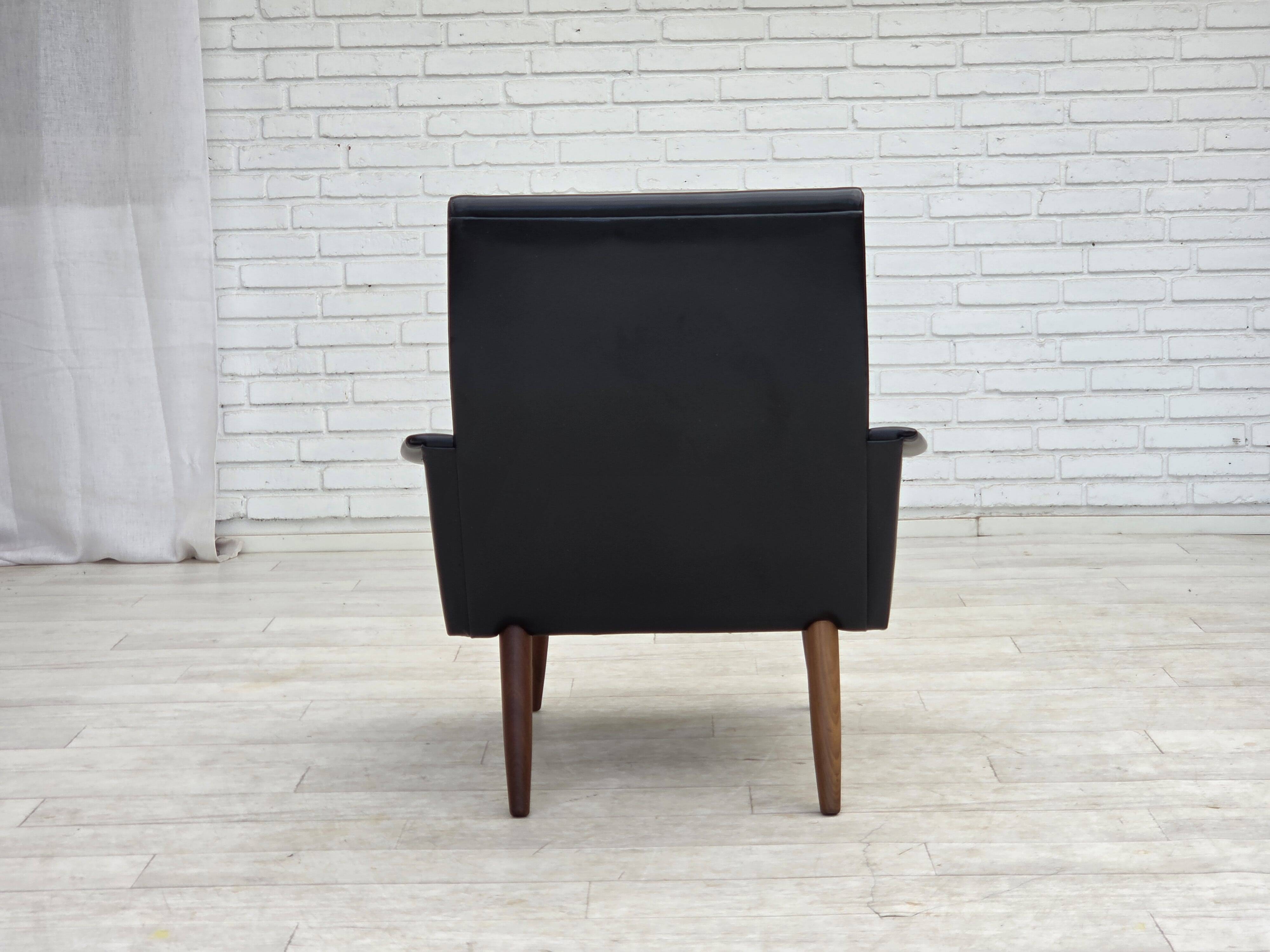 1970s, Danish armchair, black artificial leather, teak wood legs.