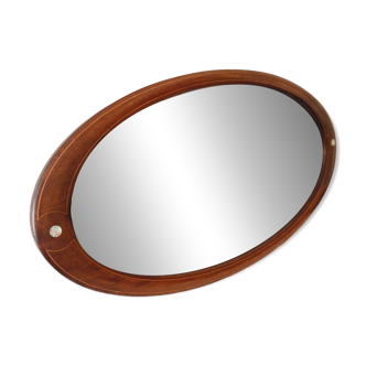 Oval mirror in wooden frame with fillets and mother-of-pearl