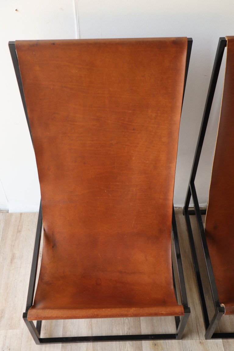 Pair of vintage armchairs in stretched leather and metal structure