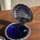Vintage silver-plated shell butter dish with blue bowl.