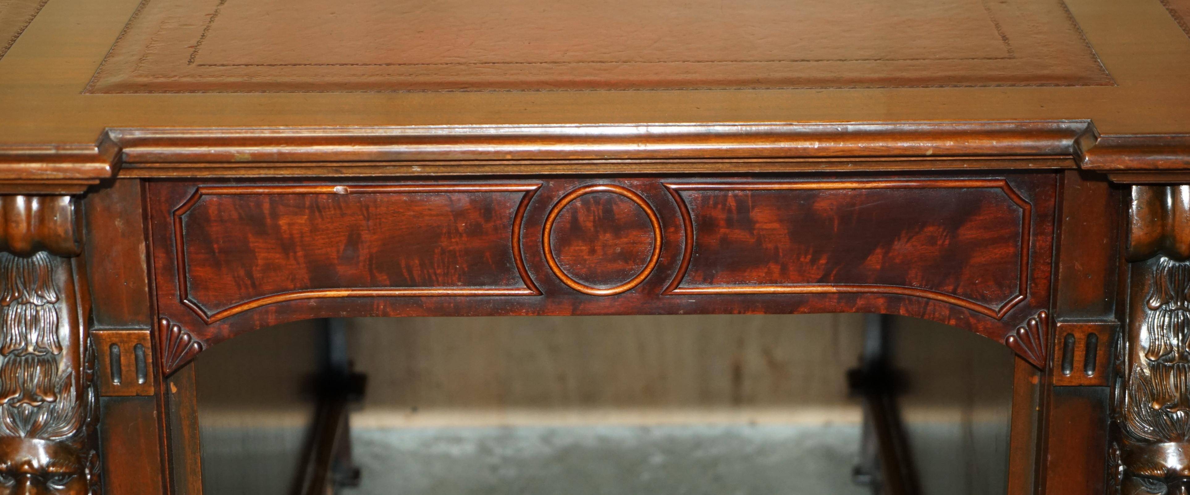 Partner desk with two carved columns featuring lion heads, according to Thomas Chippendale, restored.