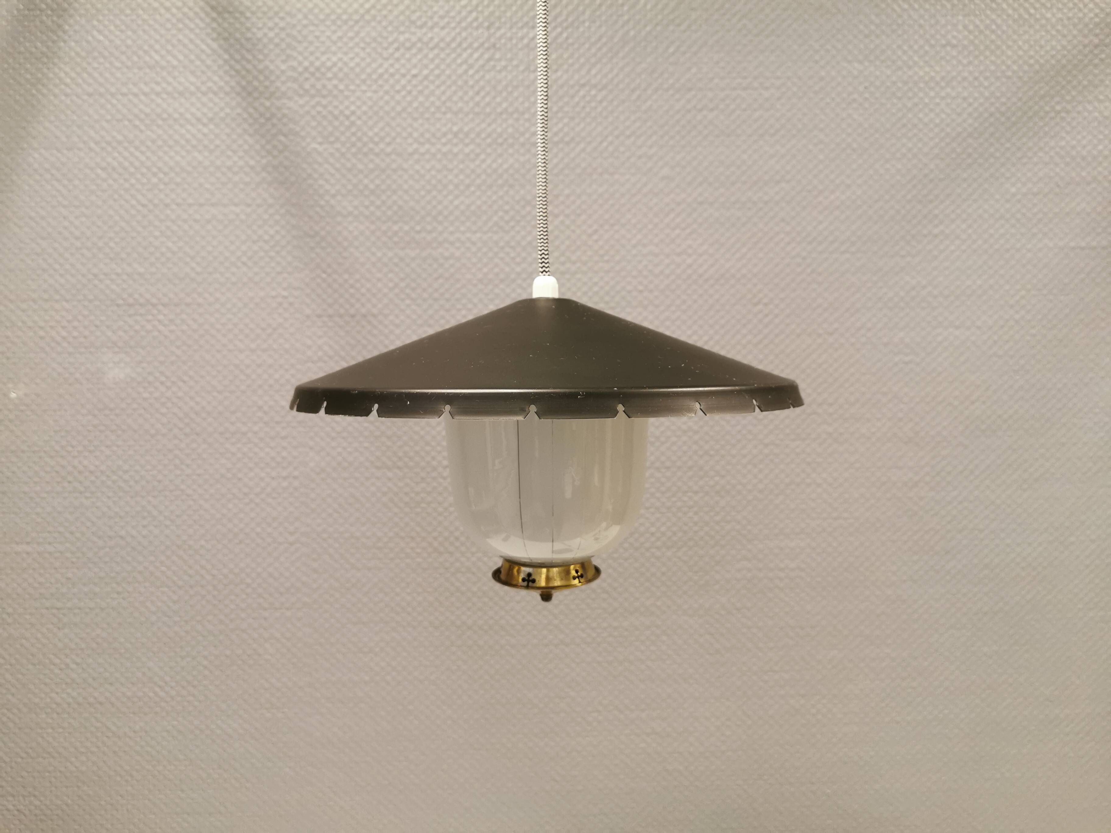 Hanging lamp in glass with black lacquered metal shade and brass base.