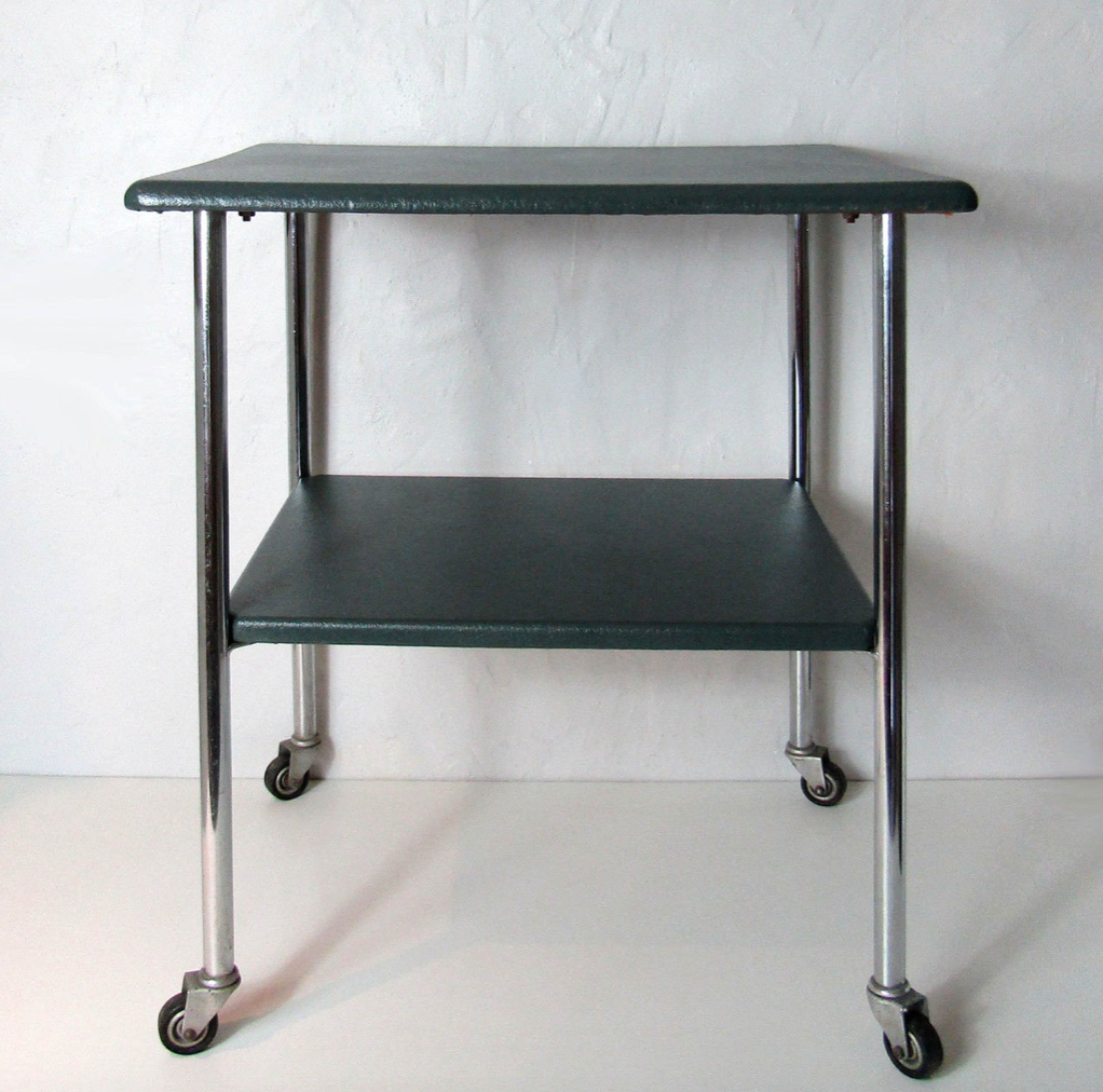 Table serves console with chrome wheels and imitation vintage khaki