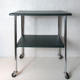Table serves console with chrome wheels and imitation vintage khaki