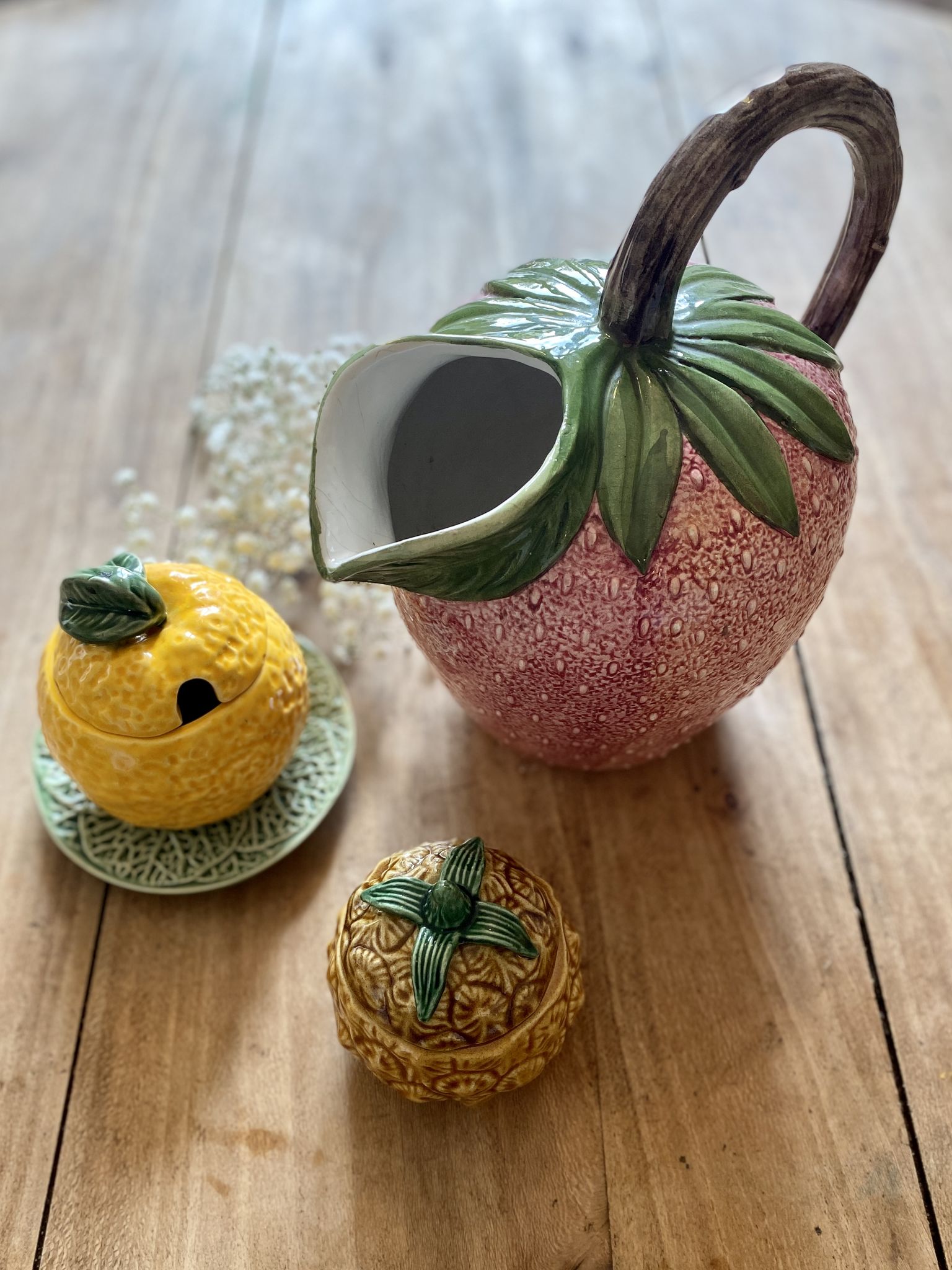 Set of ceramic fruits, a strawberry decanter and two lemon and pineapple jam jars