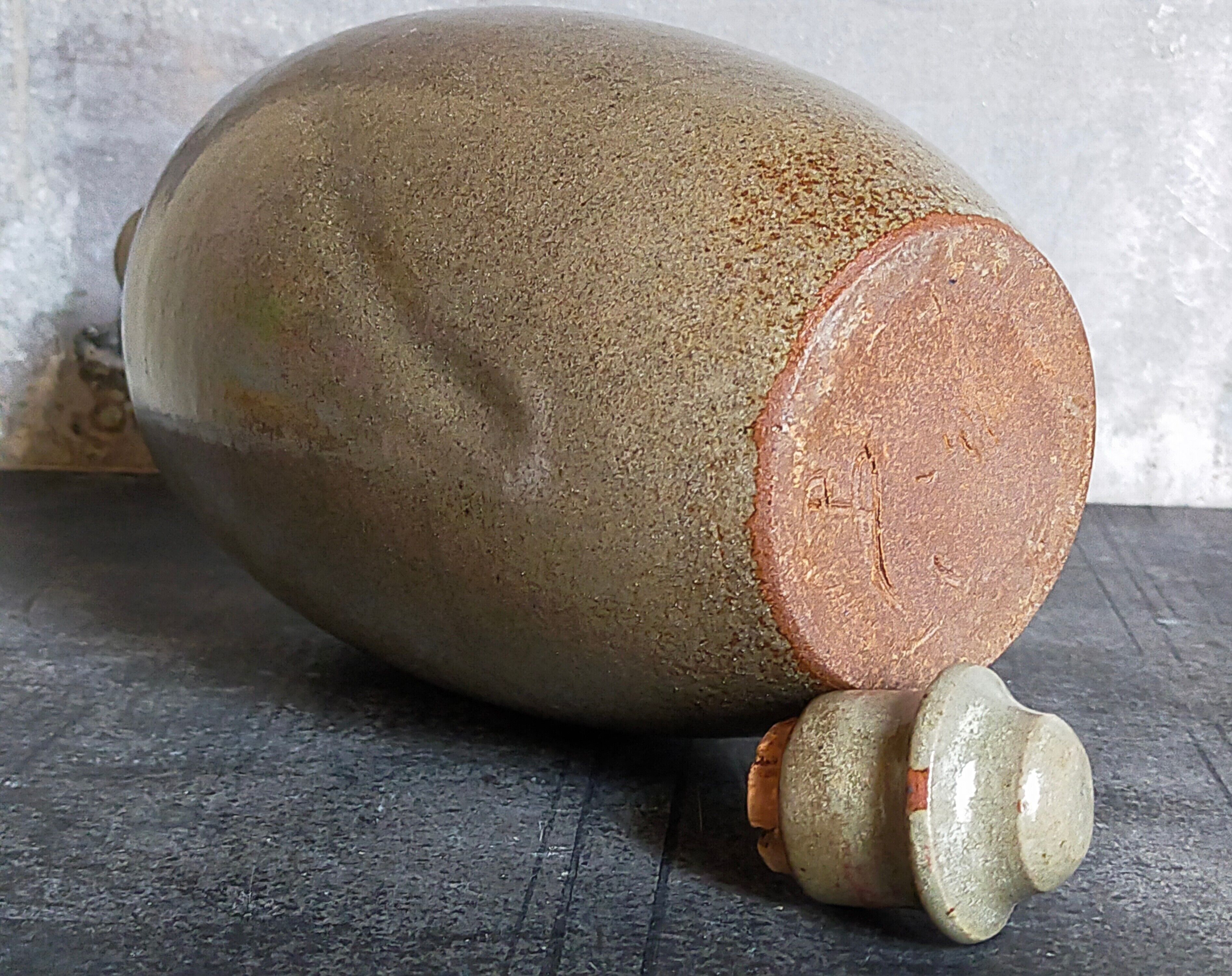 Vintage glazed stoneware potter's liquor bottle