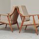 Pair of Boomerang-style armchairs in ecru beige fabric, 1960s.