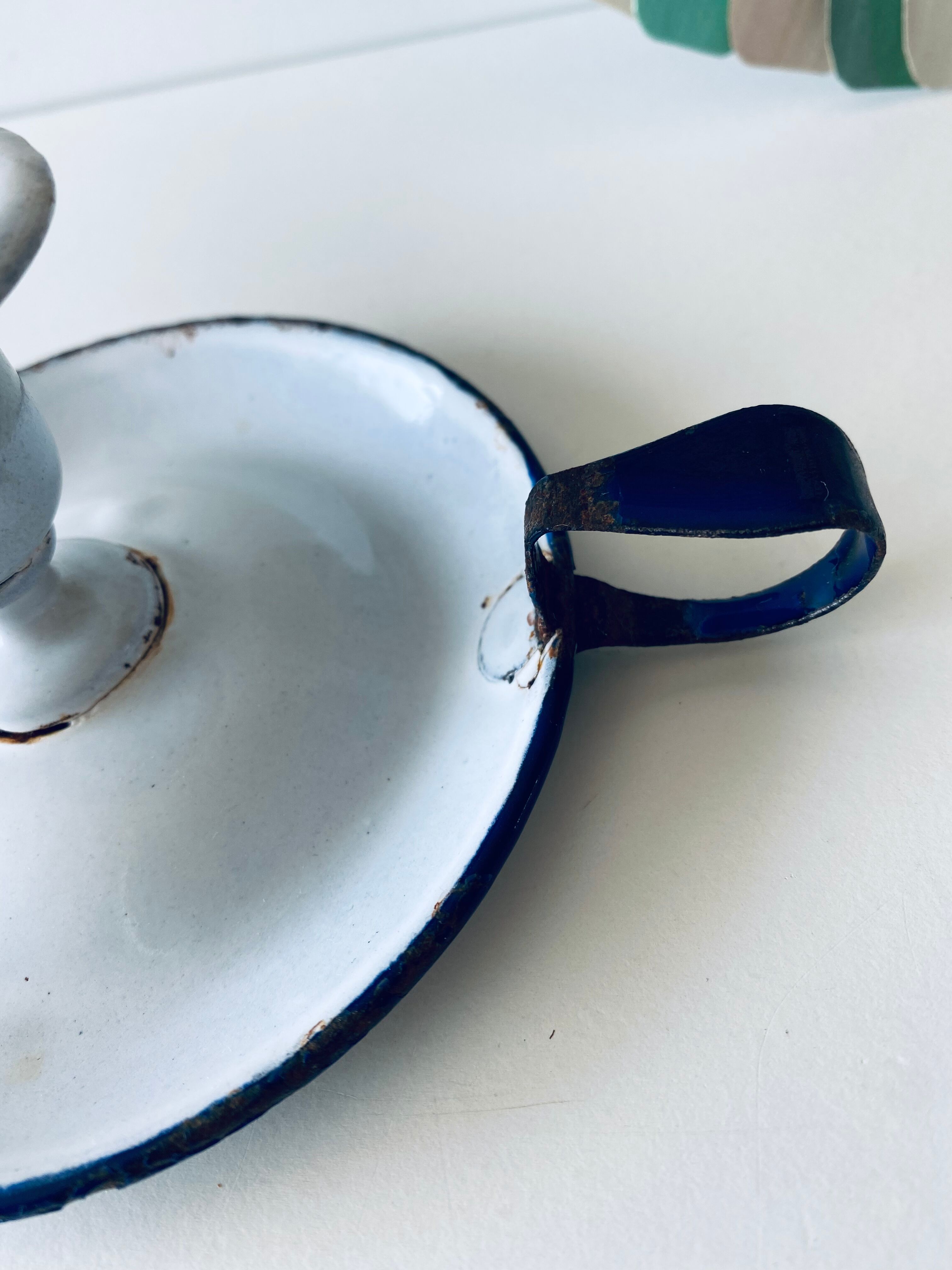 Antique candle holder in white and blue enamelled metal