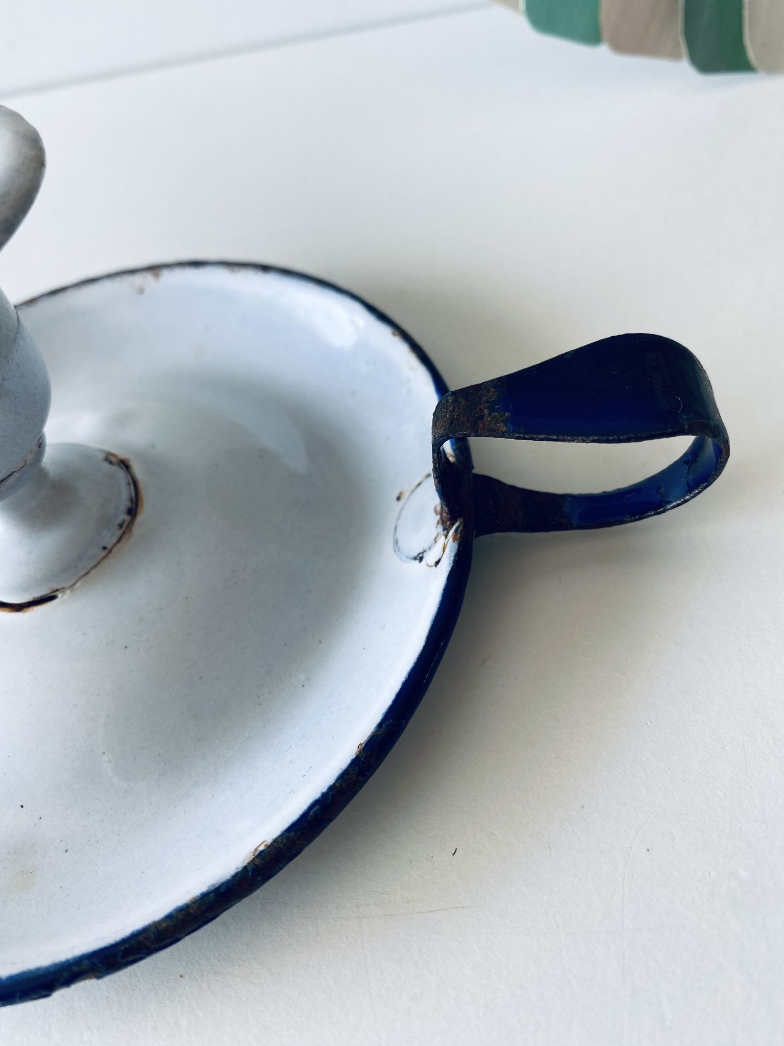 Antique candle holder in white and blue enamelled metal