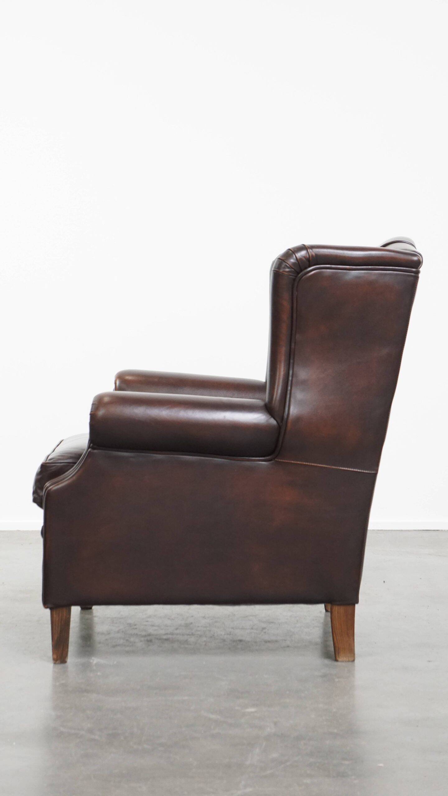 Very beautiful wing chair made of cowhide leather in English style