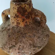 Textured terracotta vase in wabi-sabi style