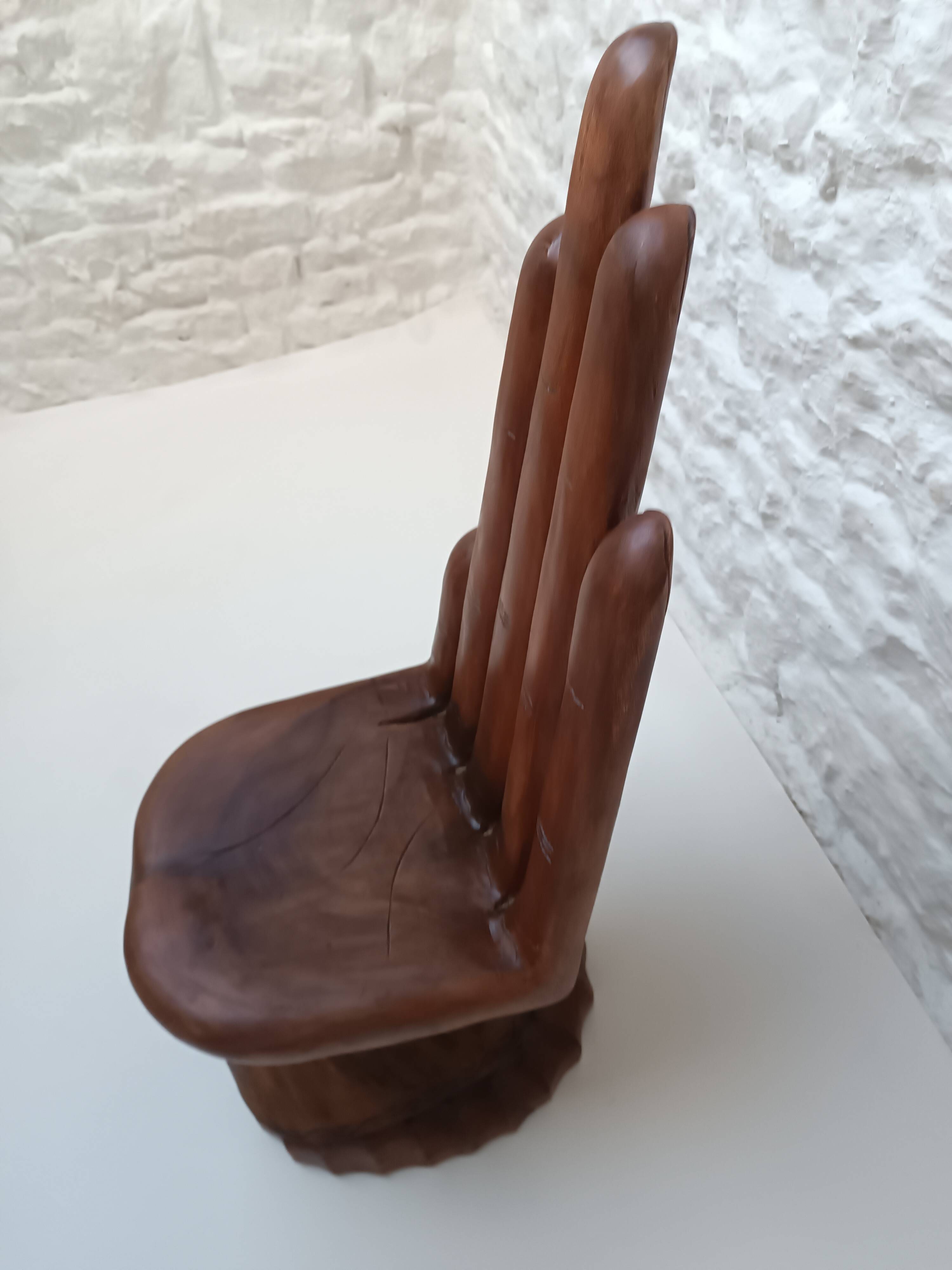 Sculpted wooden chair in the shape of a hand, 1960.