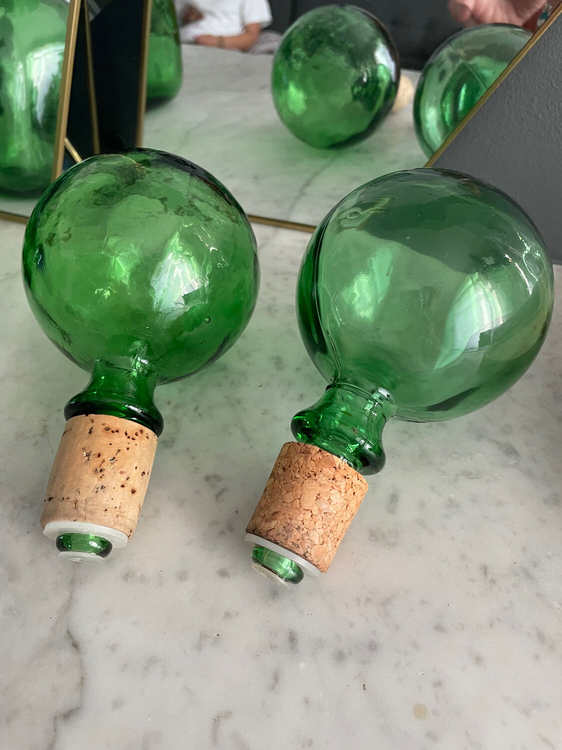 Two green glass decanters