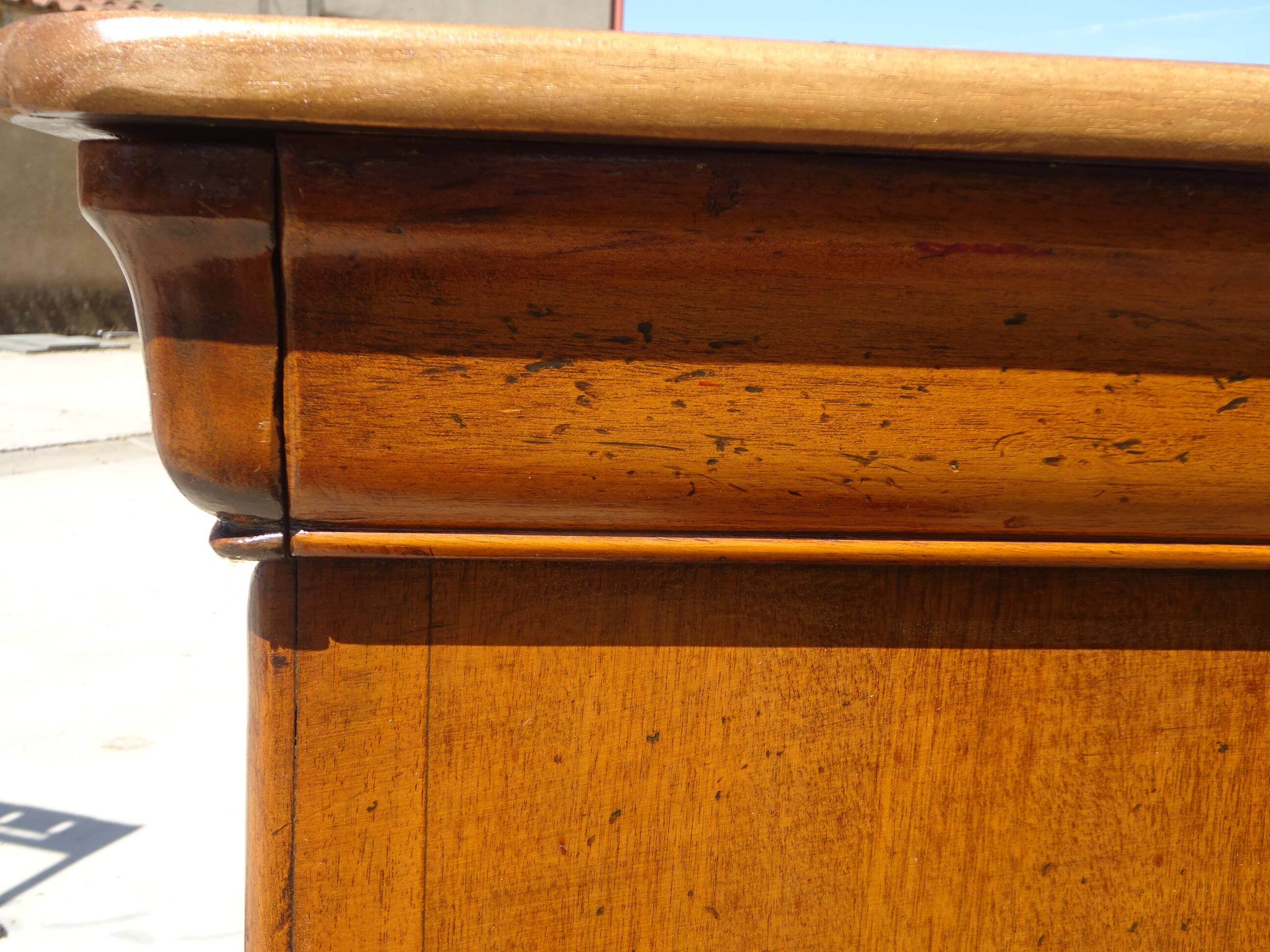 Chest of drawers with decorated handles in the Louis XVI style.
