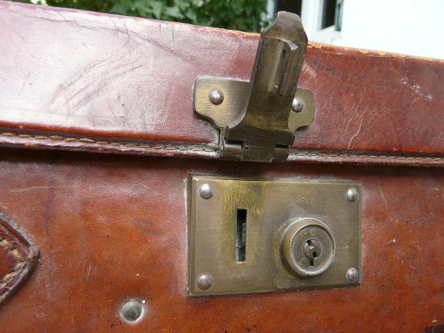 Old monogrammed leather travel suitcase and barony crown