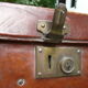 Old monogrammed leather travel suitcase and barony crown