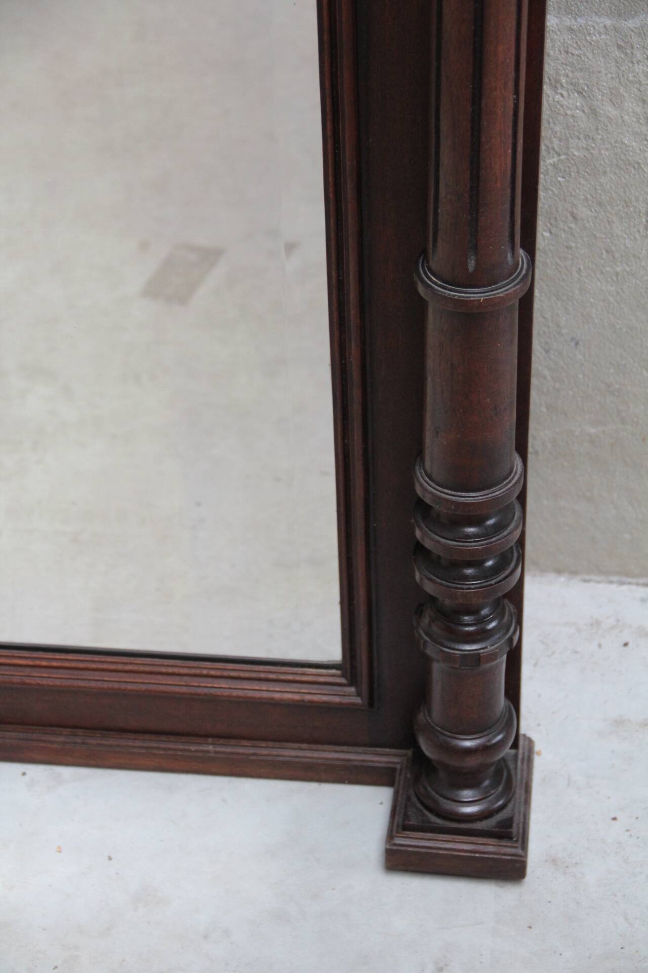 Imposing beveled mirror with wooden frame
