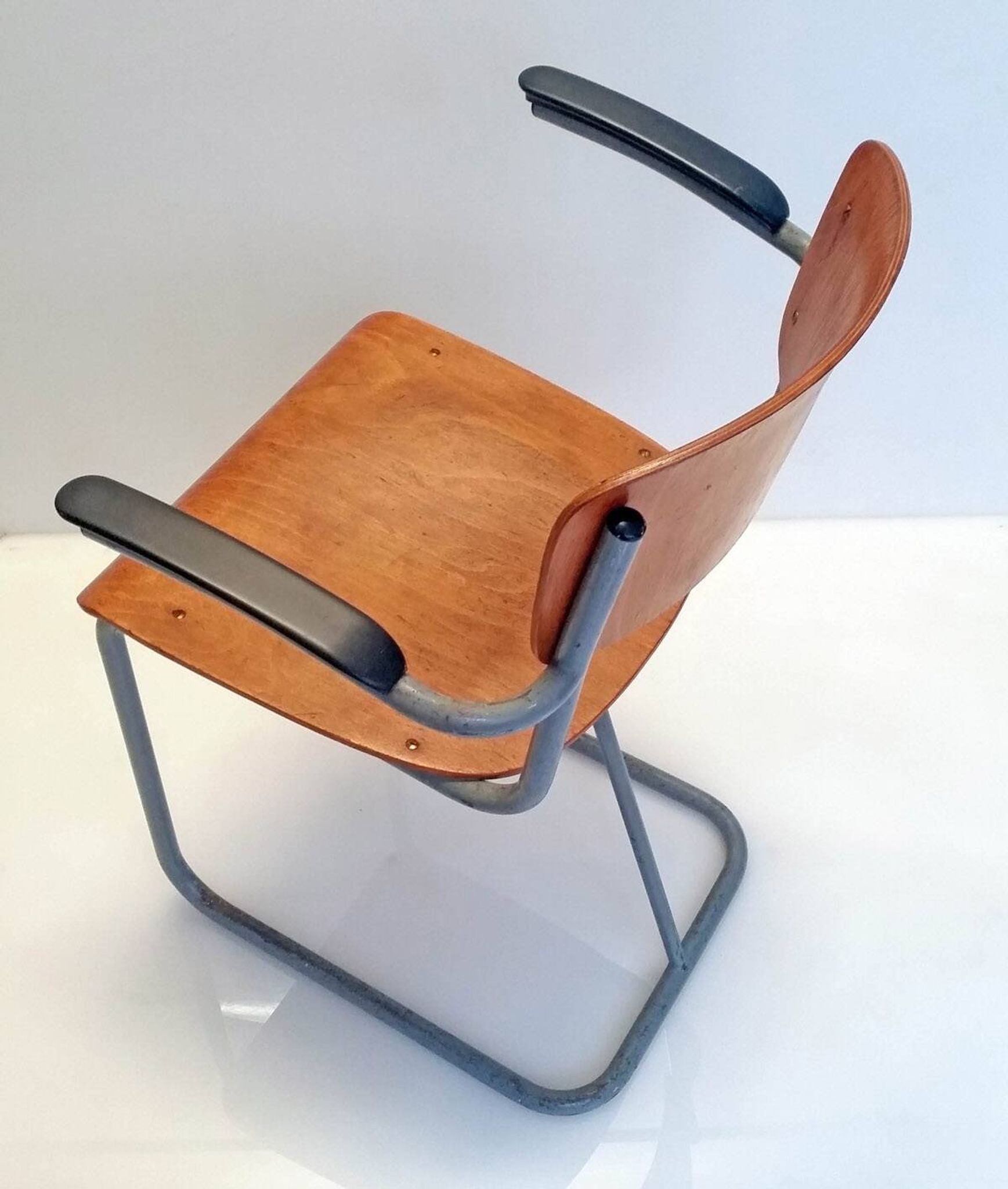 Dutch plywood vintage forties chair with bakelite armrests