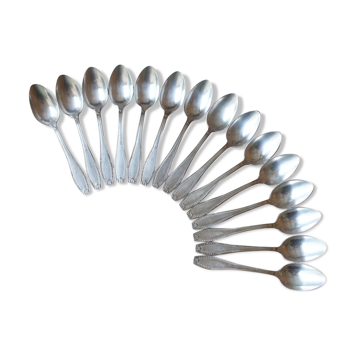 15 small silver metal spoons with rows of beads